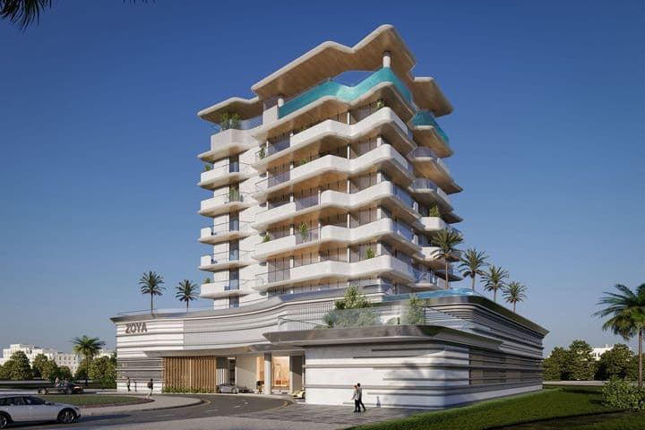 Modern multi-story building with balconies, rooftop pool, and minimalist design, surrounded by palm trees and clear blue sky.
