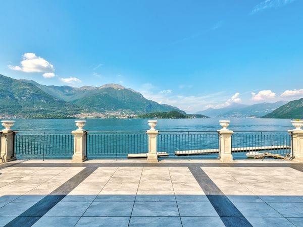 Elegant checkered stone terrace with balustrades overlooking Lake Como and the mountains