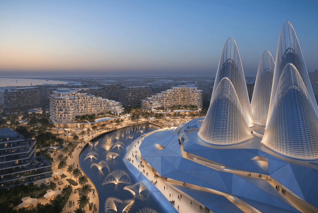 Futuristic architectural complex with cone-shaped structures, surrounded by modern buildings and illuminated fountains at dusk.