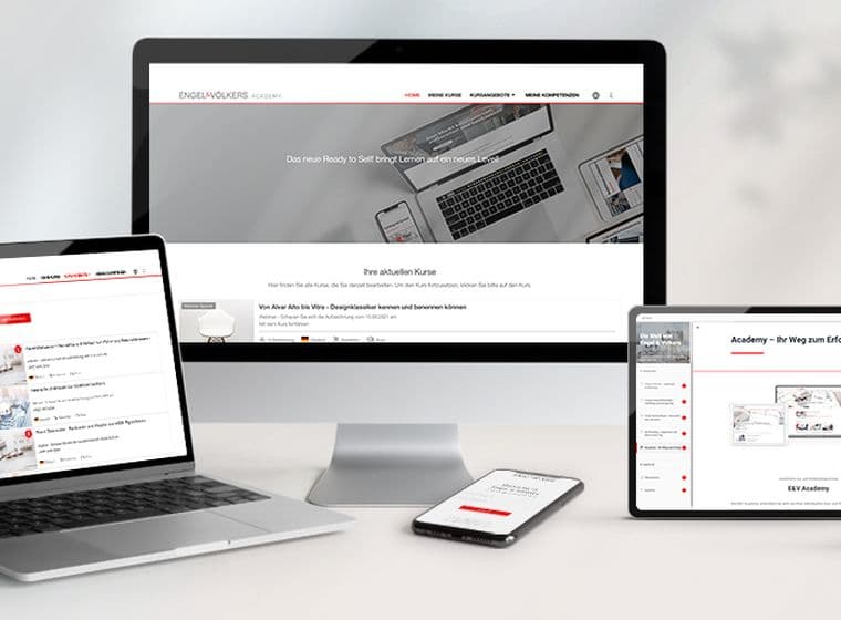 Engel & Völkers website displayed on a monitor, laptop, tablet, and phone.