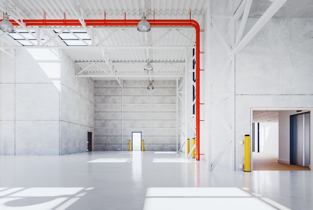 Spacious, modern warehouse interior with white walls, red pipes, skylights, and open doorways. Bright lighting and polished floor.