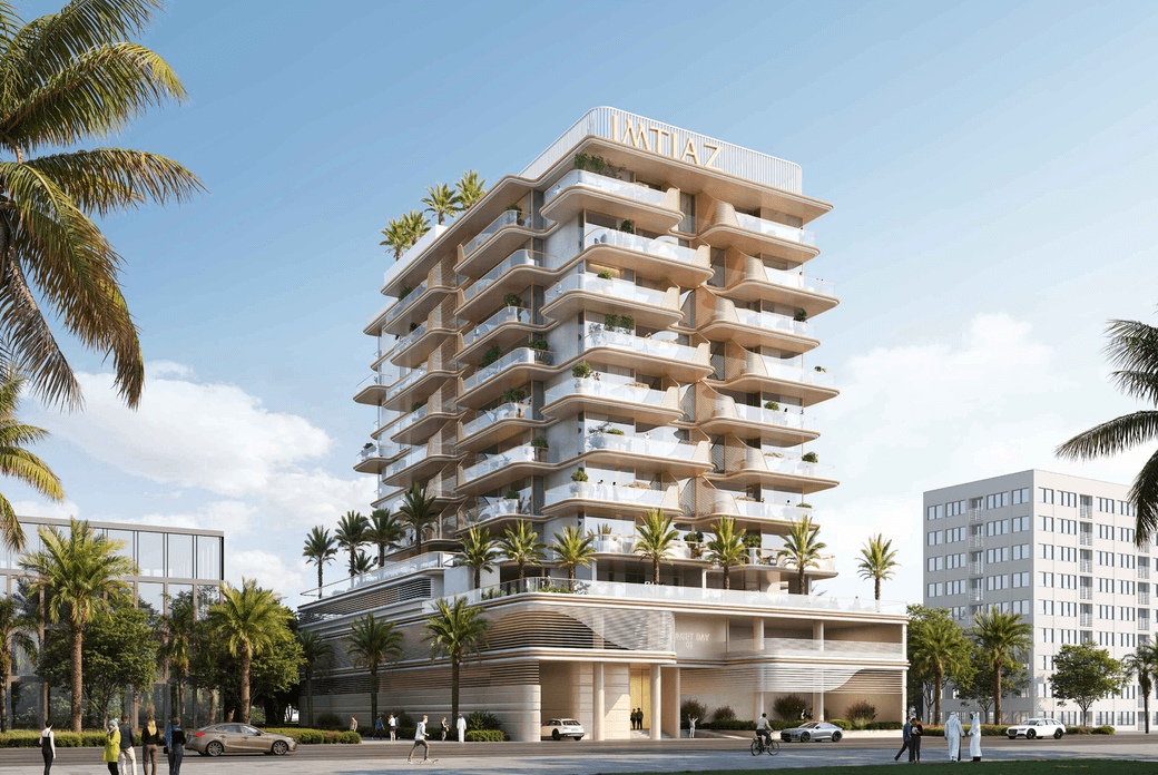 Front view of Sunset Bay 5 showing a mid rise residential building with layered balconies, integrated greenery, and a landscaped podium facing the community walkway.