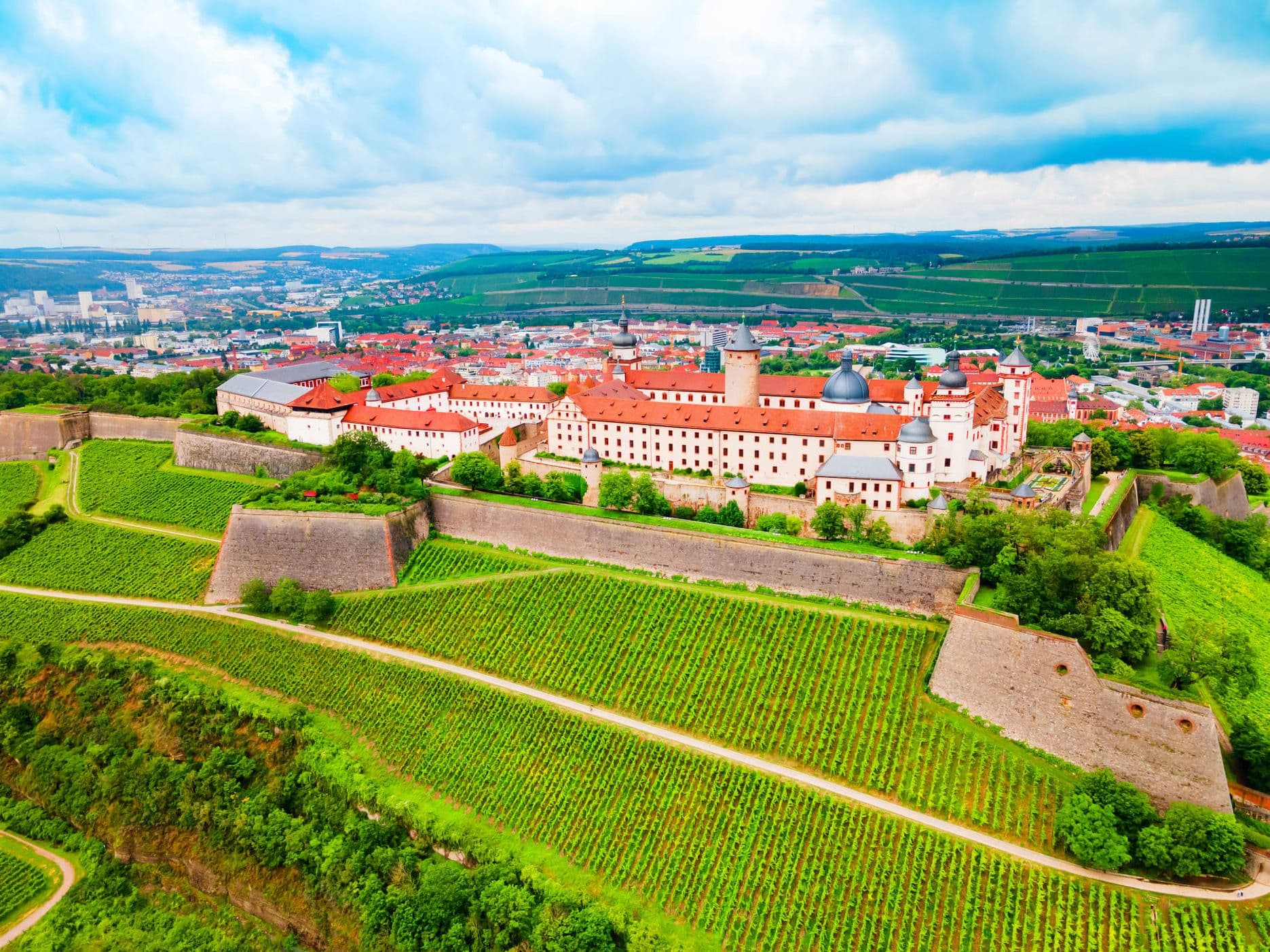 Historic Marienberg Fortress above Würzburg’s vineyards with city view in the background