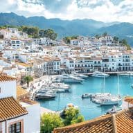 Mediterranean overseas properties in a Mediterranean coastal town with picturesque marina, terracotta roofs and mountain backdrop on the Costa del Sol