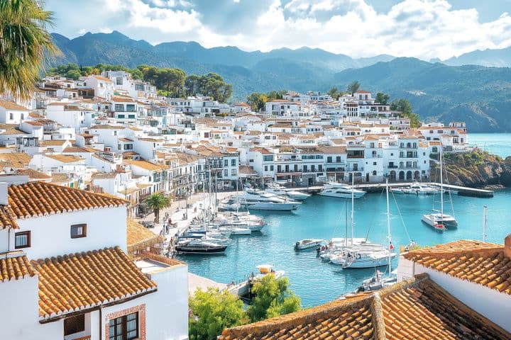 Mediterranean overseas properties in a Mediterranean coastal town with picturesque marina, terracotta roofs and mountain backdrop on the Costa del Sol
