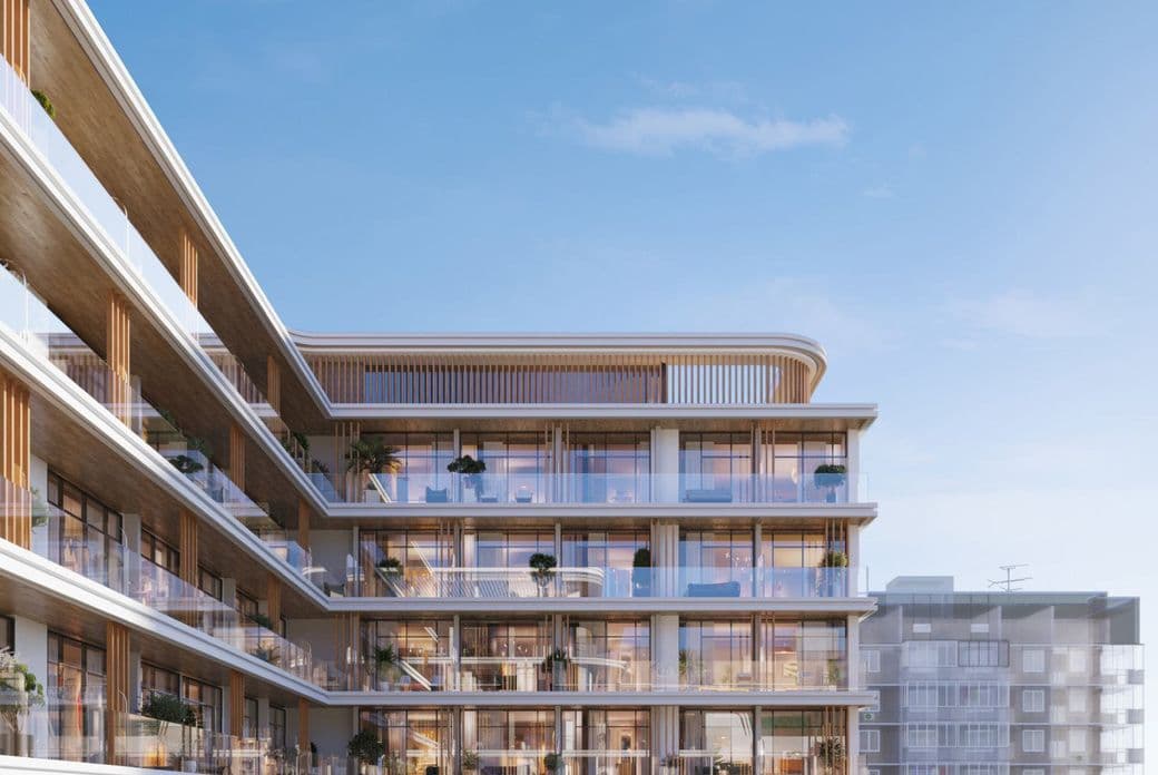 Modern multi-story building with glass balconies and wooden accents under a clear blue sky, featuring plants on several balconies.