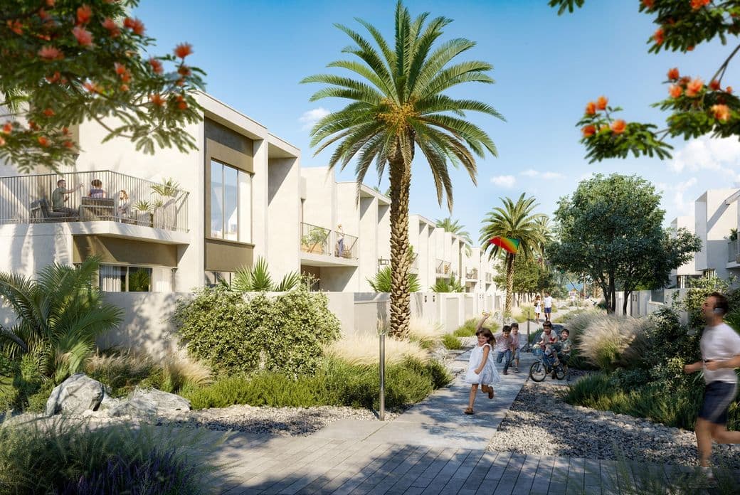 Modern residential area with palm trees, people jogging and children playing on a sunny day. Balconies overlook landscaped pathways.