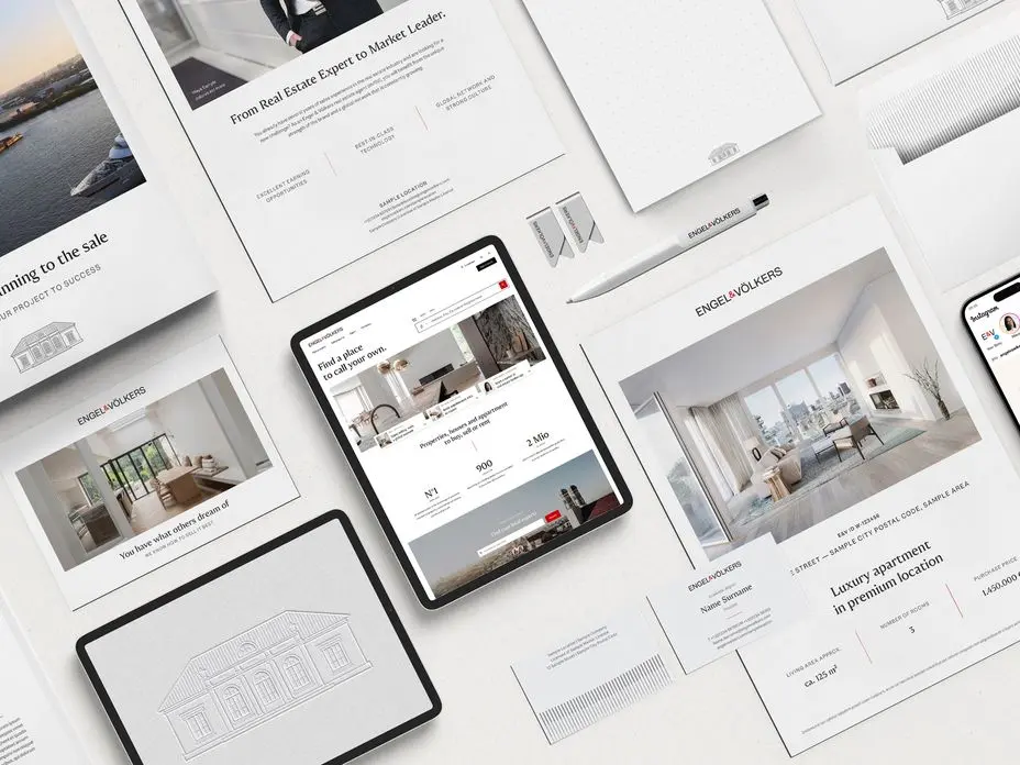 Flat lay arrangement of real estate marketing materials including iPads, smartphones, and print documents displaying luxury property listings, architectural sketches, and interior designs in a clean white minimalist style