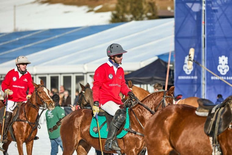 A polo player on a white horse at the snow polo tournament in Kitzbühel.