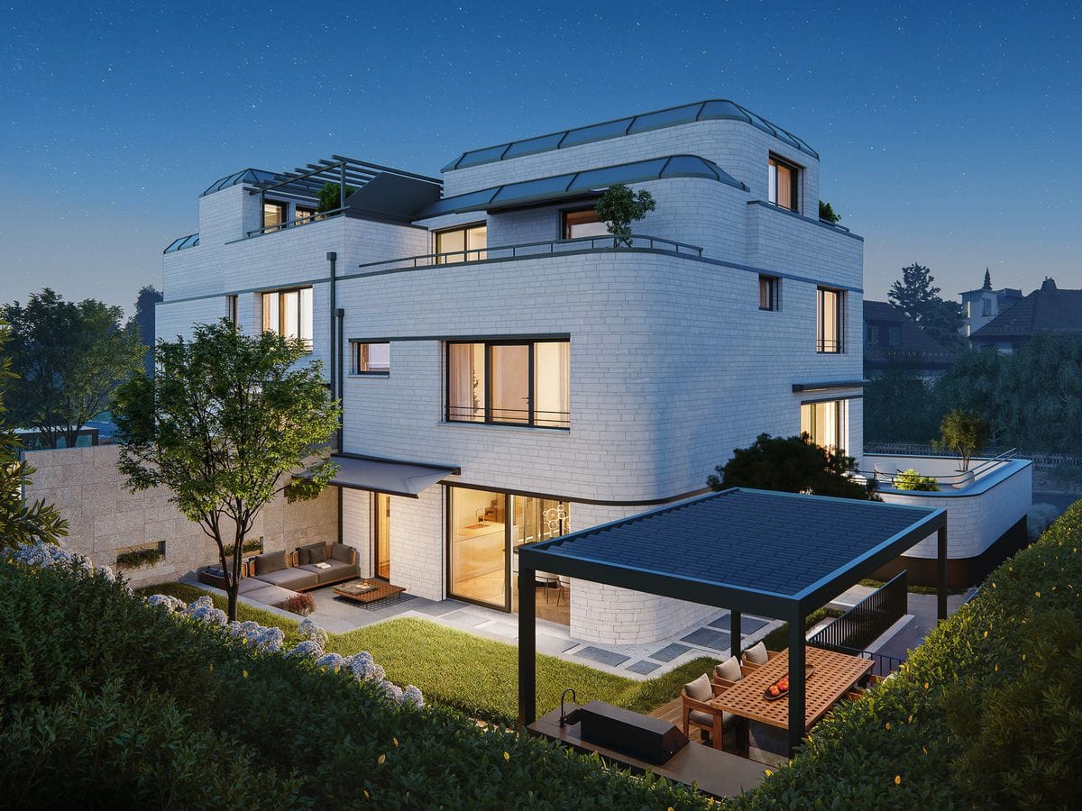 Modernes mehrstöckiges Haus mit großen Fenstern, Sitzgelegenheiten im Freien und einem gepflegten Garten, der in der Abenddämmerung vor einem klaren Sternenhimmel beleuchtet wird.