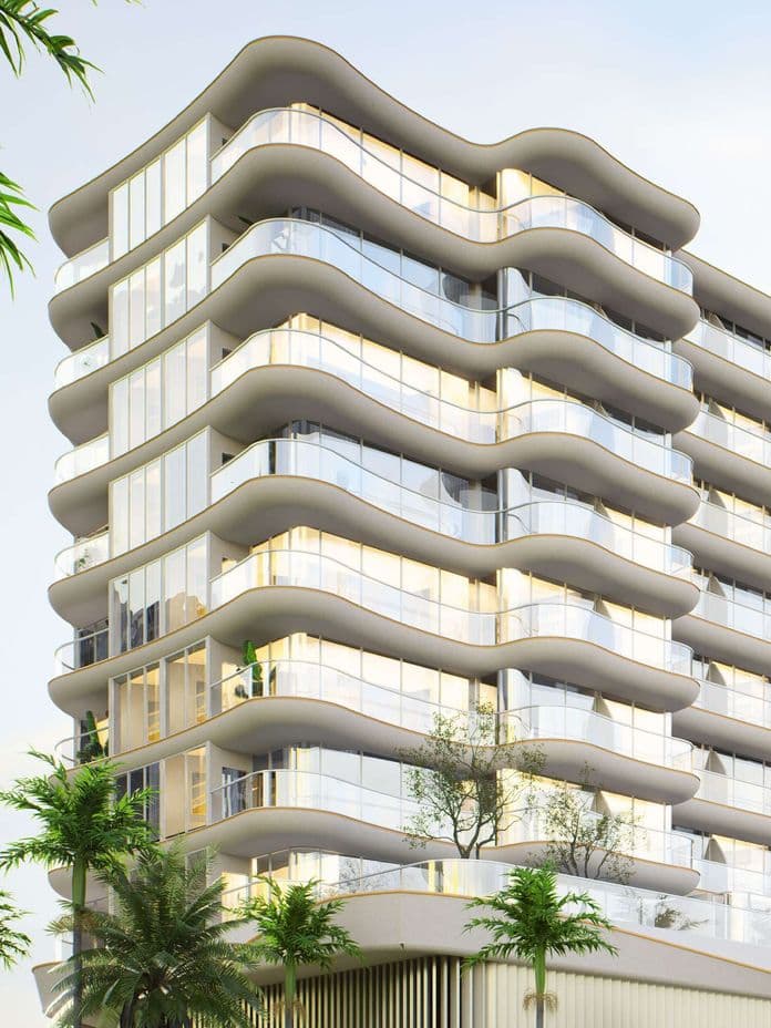 Modern multi-story building with wavy balconies and large windows, surrounded by palm trees, against a light sky.