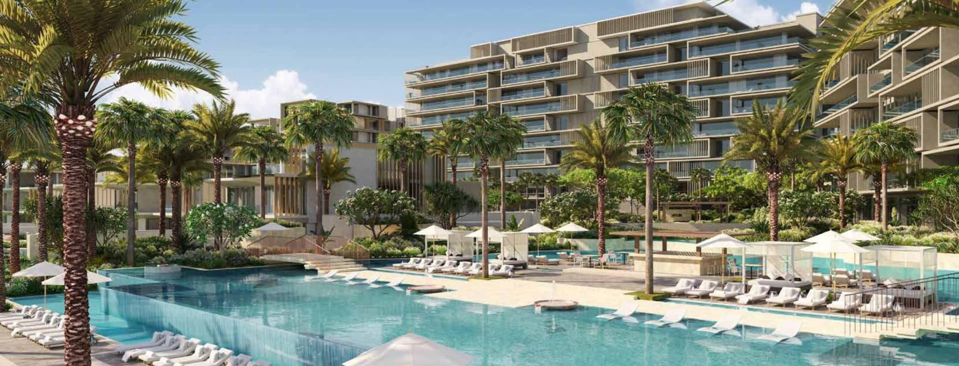 Luxurious Six Senses resort with modern buildings, palm trees, and a large pool surrounded by sun loungers and umbrellas under a clear blue sky.