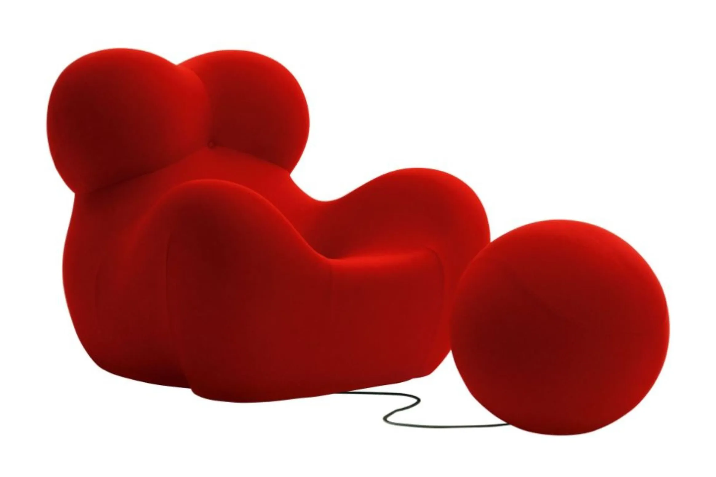 A bright red modern lounge chair with smooth, rounded curves sits next to a matching red ball connected by a thin cord.