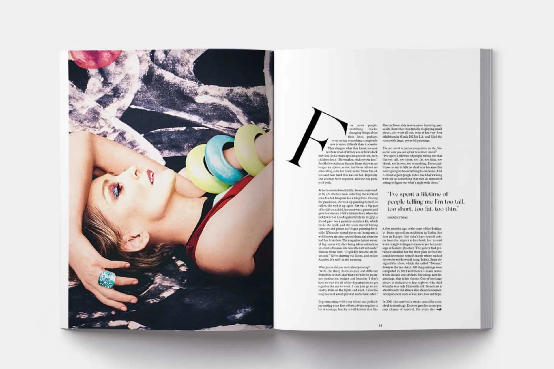 An open magazine page: On the left-hand page is a close-up portrait of a woman wearing colorful bracelets; on the right-hand page is the article text with a large “F.”