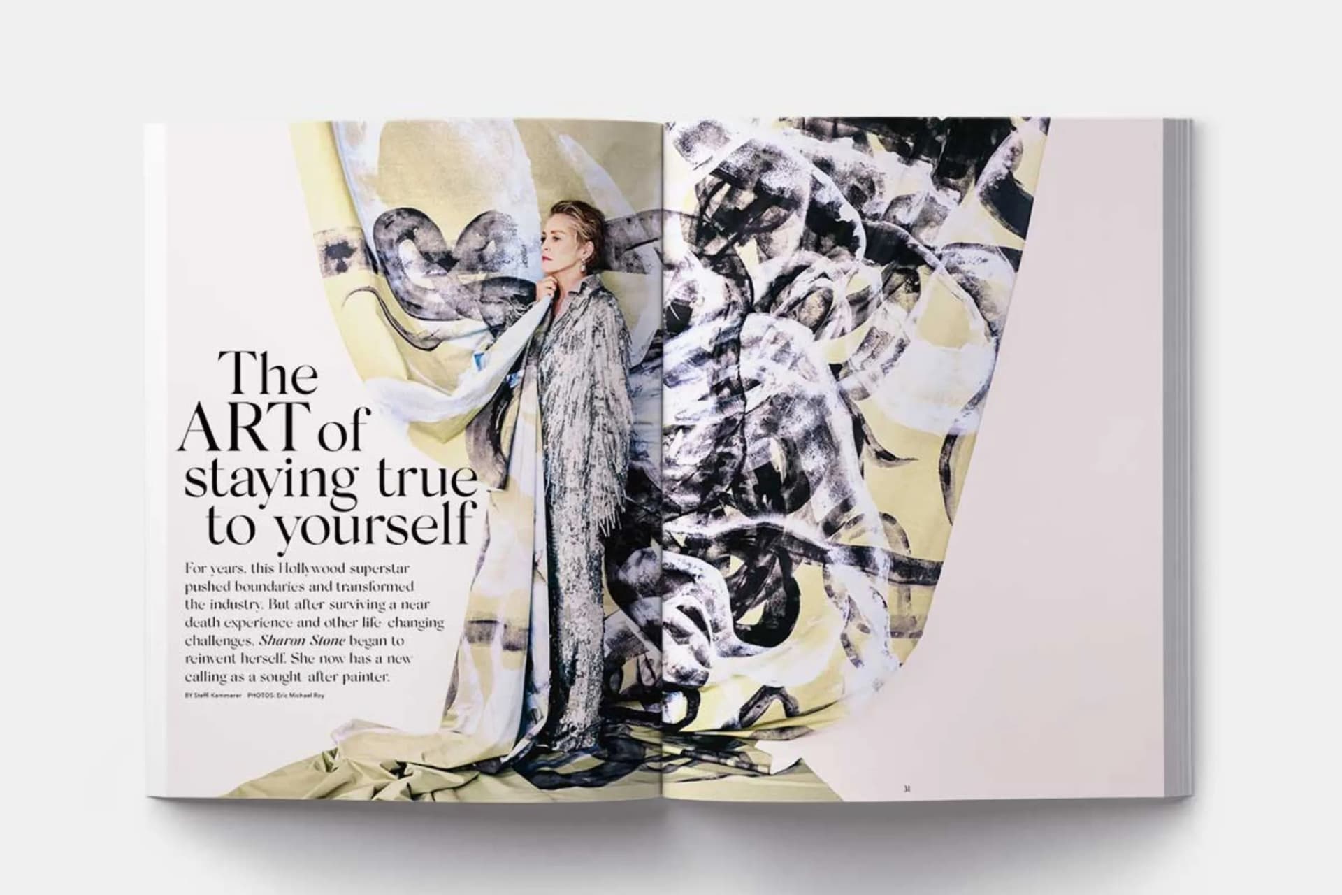 Open magazine spread featuring a person posing beside bold abstract art; left page reads 'The ART of staying true to yourself'.