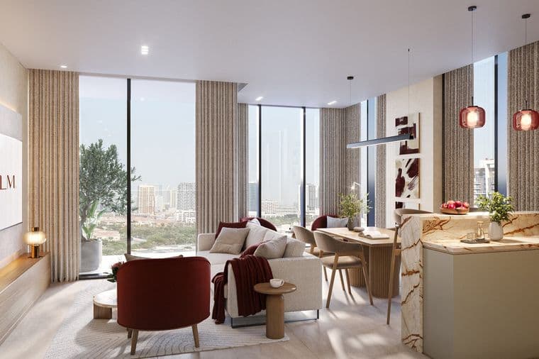 Modern living room with large windows, a cozy sofa, red chairs, and a marble kitchen island. Cityscape view in the background.