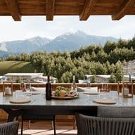 Terrace with set table and view of the Tyrolean mountains and Seefeld.