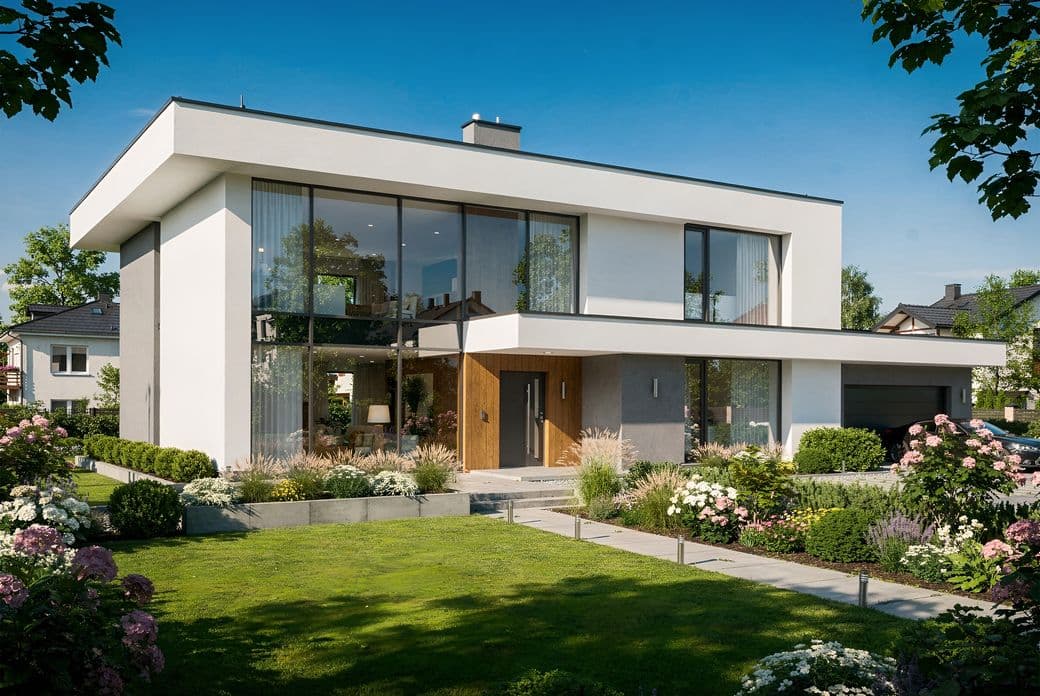 Modern two-story house with large glass windows, surrounded by a lush garden and lawn under a clear blue sky.
