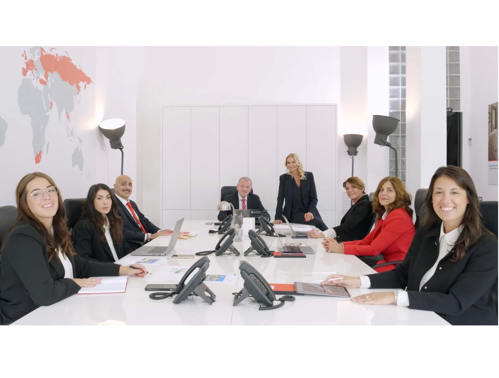 Engel & Völkers Lake Como team of advisors around a conference table in the office