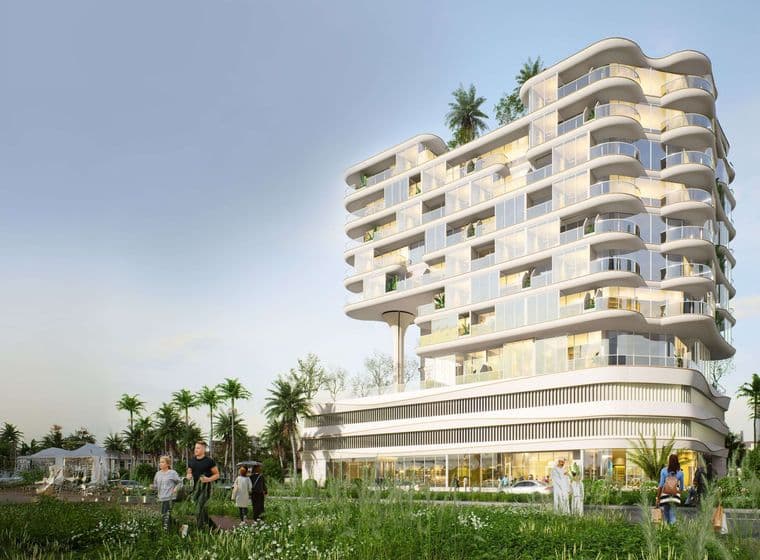 Modern, multi-story white building with curved balconies, surrounded by greenery and palm trees, people walking in the foreground.