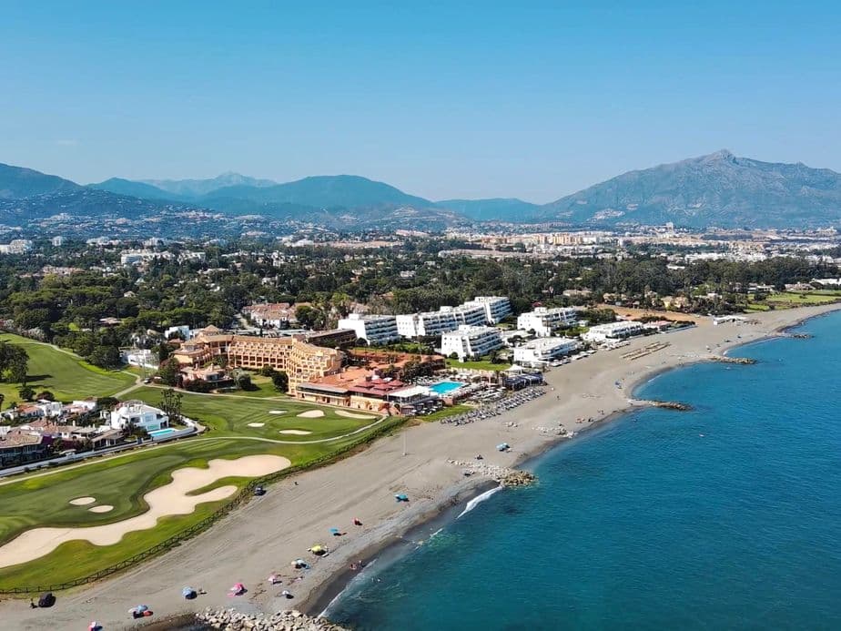 Aerial view of Marbella West from the sea with golf courses and La Concha mountain at the background