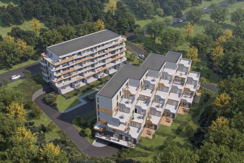 Aerial visualization of the Terasy Sylván residential development featuring two modern apartment buildings with spacious terraces and balconies, surrounded by greenery, mature trees, and landscaped outdoor areas. Obrázek vygenerovaný umělou inteligencí