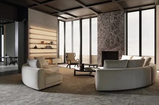 Modern living room with a dark wood grid ceiling, tall glass windows, a marble fireplace, and curved beige sofas.