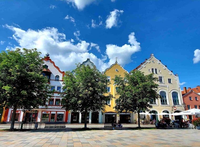 View of Marienplatz in Weilheim, Germany, with colorful historic gabled houses, street cafés and lively old town atmosphere