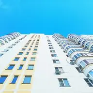 view of a high building, with lots of windows and no balconies