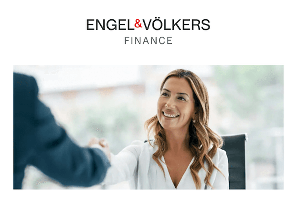 Professional financial consultation scene with a smiling advisor in white business attire meeting with a client, underneath the Engel & Völkers Finance logo, depicting a welcoming and professional financial services environment