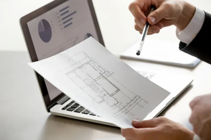 Real estate agent holding a cadastral record to verify the property details.
