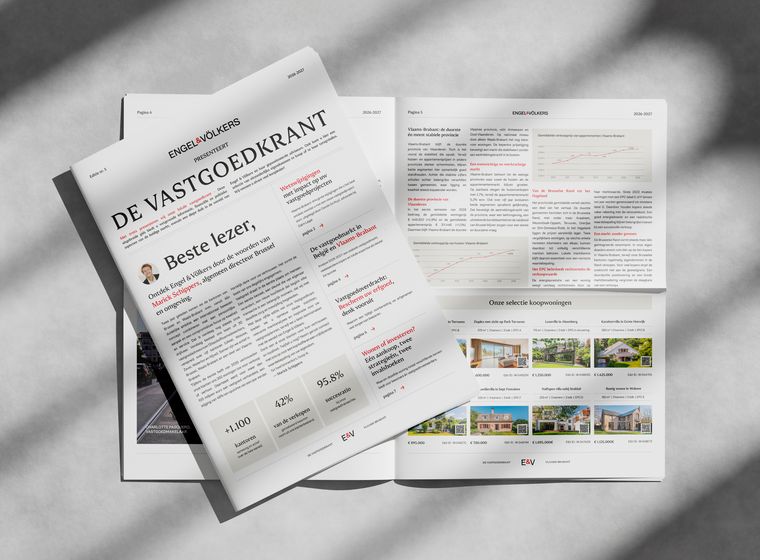 Monochrome image of a folded real estate newspaper titled DE VASTGOEDKRANT with Engel & Völkers branding, spread open.