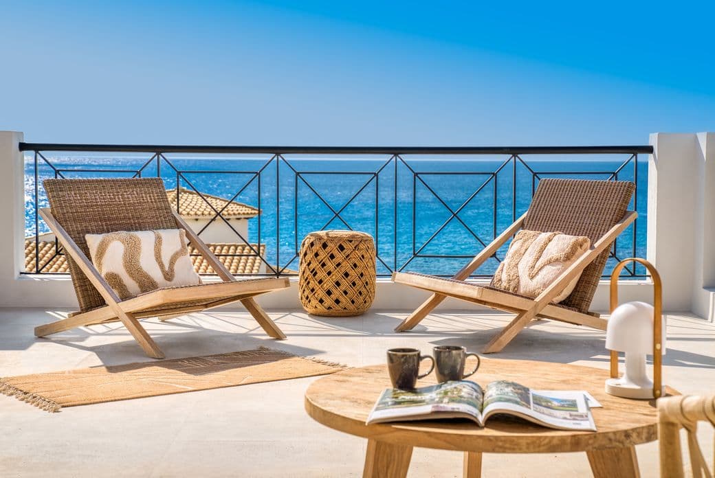 Terrace with two chairs and a small table overlooking the sea, typical of Menorca