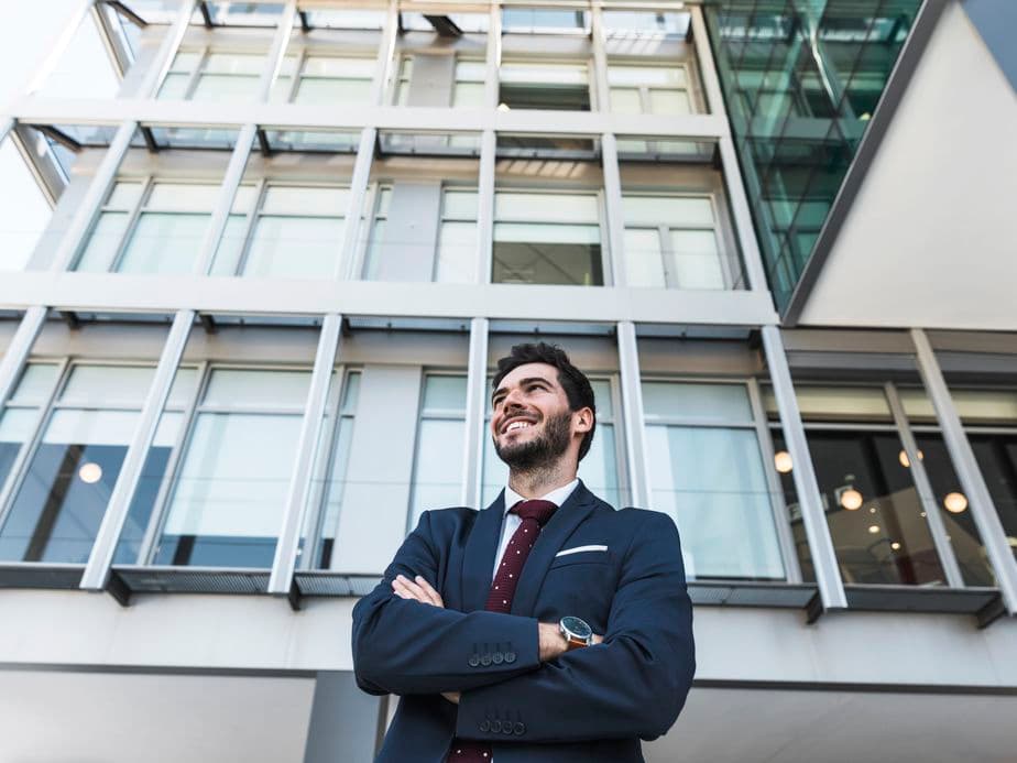 low-angle-smiley-lawyer-with-crossed-arms