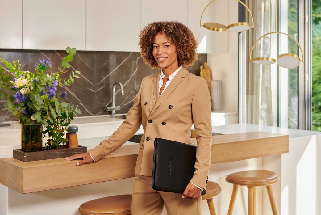 A woman is standing in the kitchen