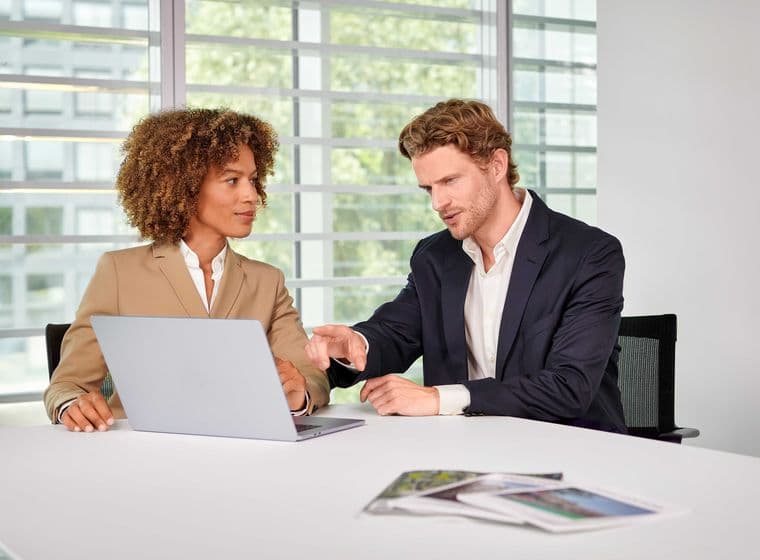Customer service in the office with a view of a laptop