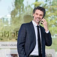 Man in front of a shop window at work