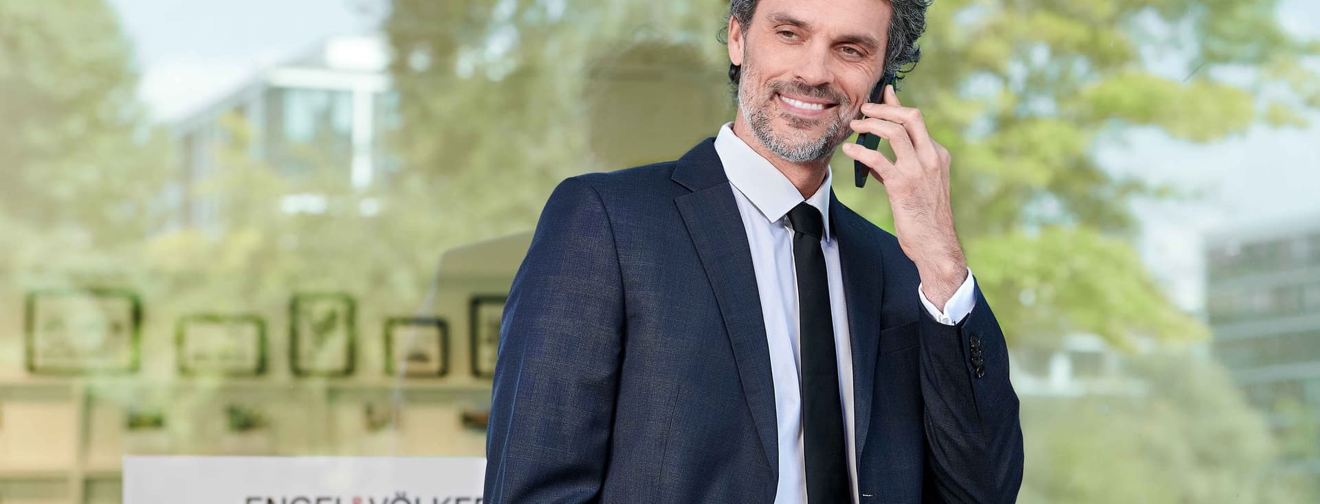 Man in front of a shop window at work