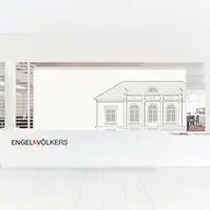 Black and white architectural line drawing of an elegant classical-style building with arched windows and decorative details, displayed on a white background with the Engel & Völkers logo beneath. The image is framed by a bright, modern interior setting with venetian blinds visible in the background.